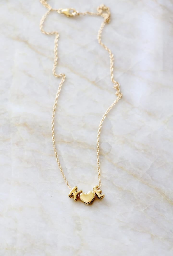 Gold necklace on a marble surface