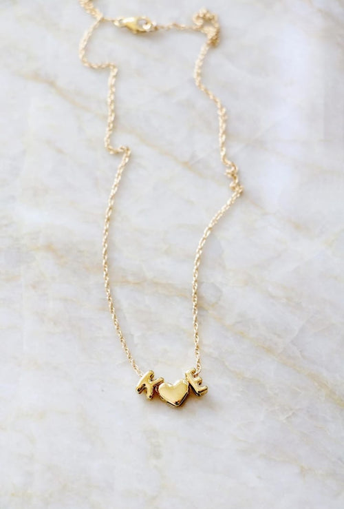 Gold necklace on a marble surface