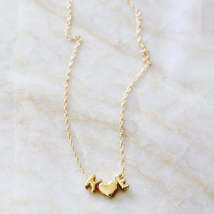Gold necklace on a marble surface